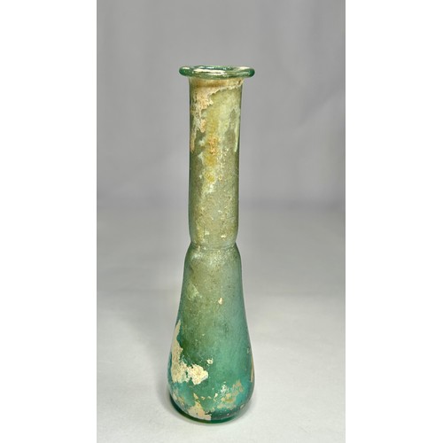 118 - Roman Glass Unguentarium. Circa 1st-2nd century CE. 126mm. A blue/green glass bottle with an elongat... 