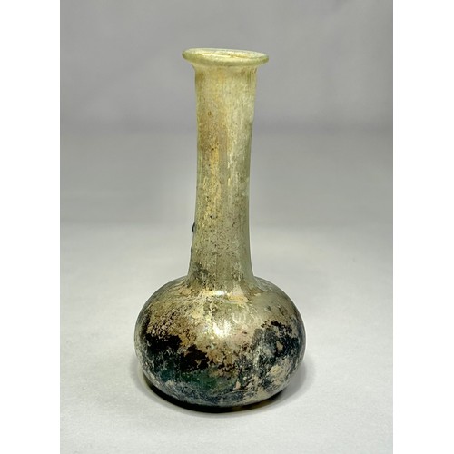 119 - Roman Glass Unguentarium. Circa 1st-2nd century CE. 84mm. A clear / iridescence glass bottle with an... 