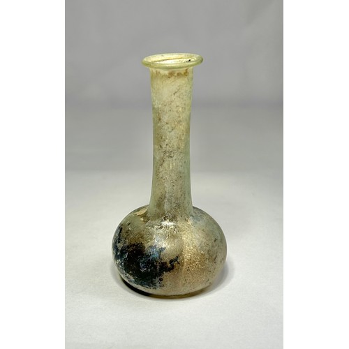 119 - Roman Glass Unguentarium. Circa 1st-2nd century CE. 84mm. A clear / iridescence glass bottle with an... 