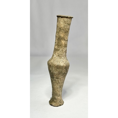 120 - Roman pottery Unguentarium. Circa 1st-2nd century CE. 122mm. A dark grey clay bottle with an elongat... 