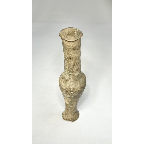 120 - Roman pottery Unguentarium. Circa 1st-2nd century CE. 122mm. A dark grey clay bottle with an elongat... 