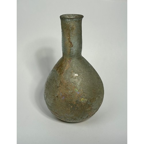 39 - Roman glass bottle. Circa 2nd century CE. 85mm x 35mm. A bulbous body with a straight sided narrow n... 