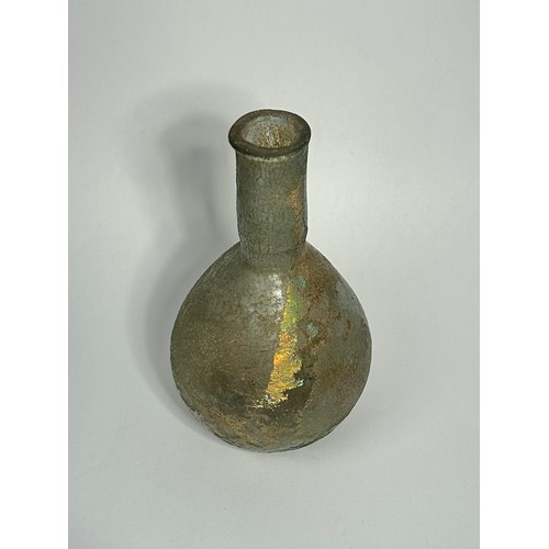 39 - Roman glass bottle. Circa 2nd century CE. 85mm x 35mm. A bulbous body with a straight sided narrow n... 