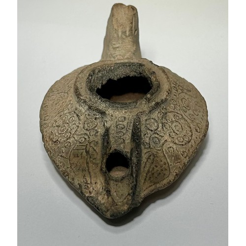 56 - Byzantine oil lamp. circa 5th-8th century CE. Decorated with foliate scrolls and circular panels of ... 