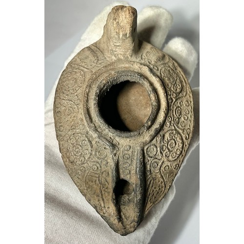 56 - Byzantine oil lamp. circa 5th-8th century CE. Decorated with foliate scrolls and circular panels of ... 