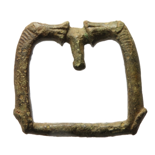 64 - Anglo-Saxon zoomorphic buckle. An elaborate cast copper alloy buckle. The frame is square and has a ... 