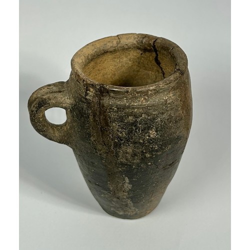 82 - 14th Century medieval pottery cup. 98mm x 55mm. A barrel-shaped vessel with a flat base and small ha... 