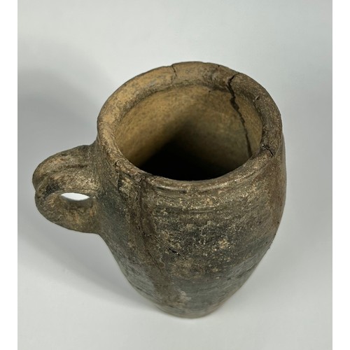 82 - 14th Century medieval pottery cup. 98mm x 55mm. A barrel-shaped vessel with a flat base and small ha... 