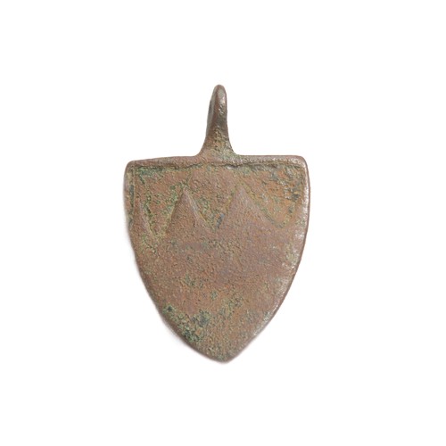 100 - Medieval heraldic harness pendant. Circa 13th century CE. Copper-alloy, 16.55g. 51mm. A shield-shape... 