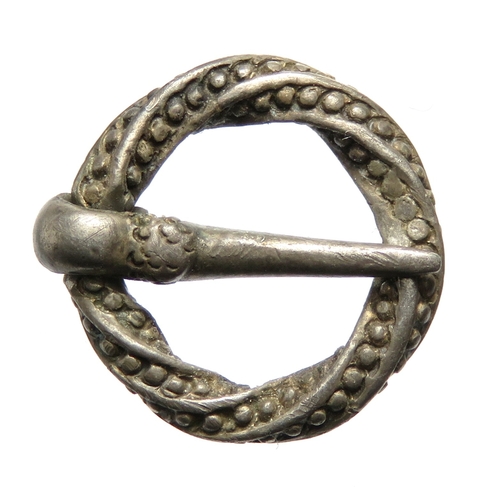 107 - A small silver Medieval annular brooch, circa 1200-1400 CE. Formed of a twisted square sectioned fra... 