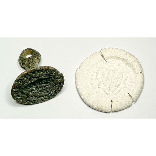 89A - Medieval Seal matrix. Circa 14th century CE. Copper-alloy, 24.68mm. A chess-piece type, the face of ... 