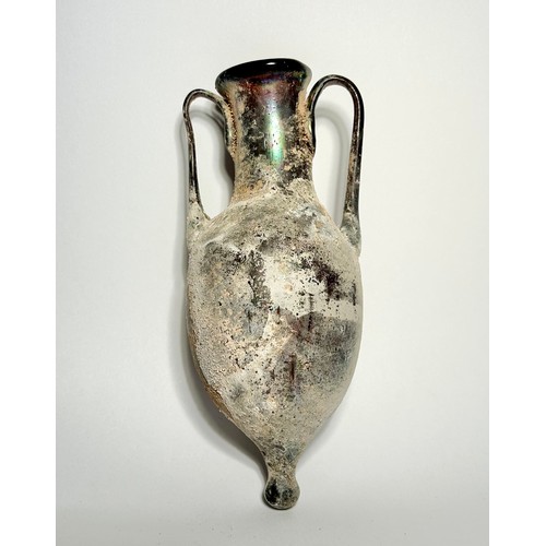 38 - Roman blown glass amphora type jug. Circa 1st-2nd century CE. 15.5 cm. A translucent purple vessel w... 