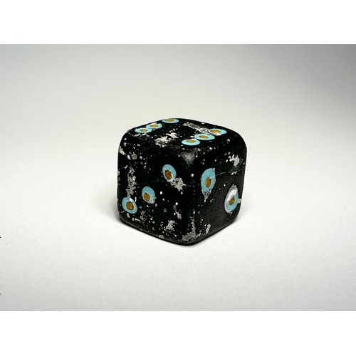 42 - Roman mosaic glass gaming die. Circa 1st century CE. 23 mm. Formed of a dark blue cube with turquois... 