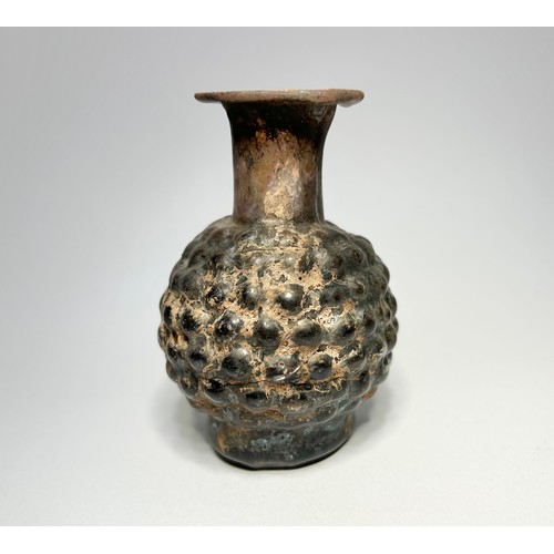 40 - Roman, Eastern Mediterranean moulded glass vessel. Circa 4th century CE. 79mm x 54mm. The bottle has... 