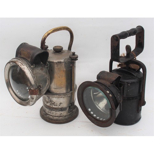 London North Western Railway carbide handlamp, LMS carbide handlamp with BR tie on label, both complete ex service condition. (2) (Postage Band: N/A)
