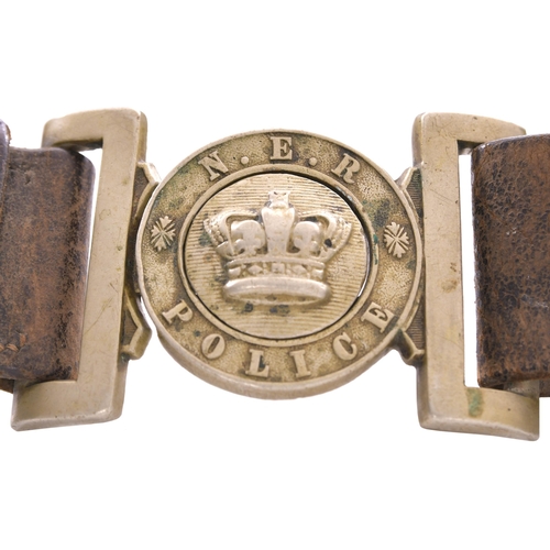 164 - A North Eastern Railway belt with a cast nickel clasp NER POLICE, with central crown and decoration,... 