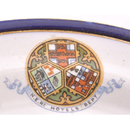 297 - A North Eastern Railway Hotels Dept tea plate, by Booths, with blue and gilt rim and multicoloured N... 