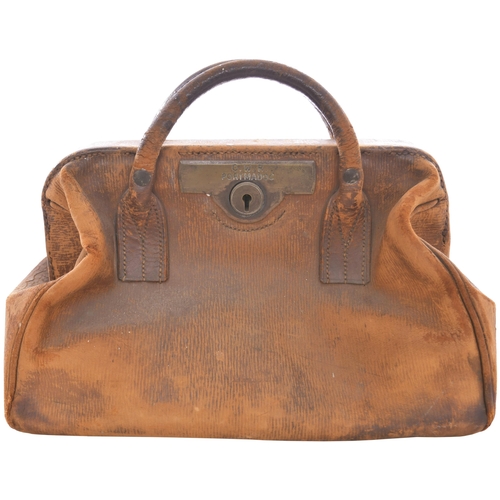 115 - A Gladstone bag, clearly engraved GWR PORTMADOC on the brass plate surrounding the lock, a station o... 