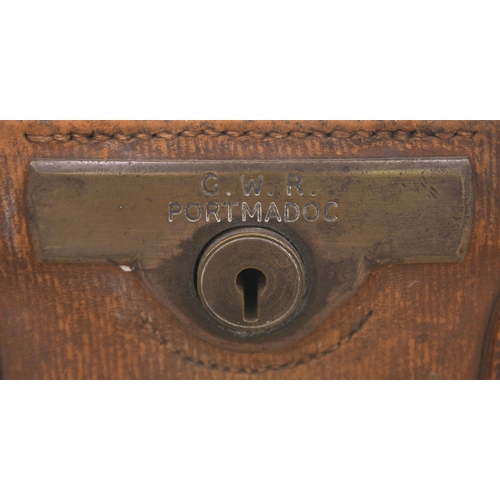 115 - A Gladstone bag, clearly engraved GWR PORTMADOC on the brass plate surrounding the lock, a station o... 