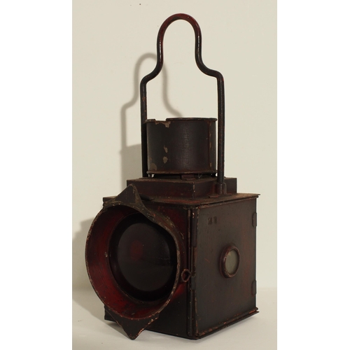Metropolitan Railway warning lamp with original red paintwork with wording "MET RY, SIGNAL BOX, NORTHWOOD" and the body clearly stamped MR. The lamp lacks its top cover and has a crack to the red lens, copper vessel, burner and filler cap present, beautiful patina, ticket nippers.(2) (Dispatch by Mailboxes/Collect from Banbury Depot)