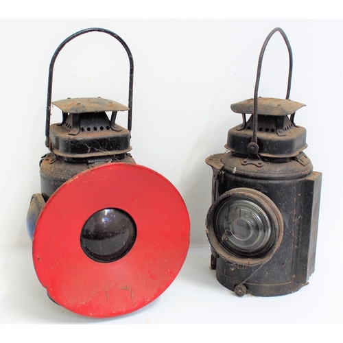 London Midland & Scottish Railway Adlake signal lamp, second lamp with cowled red lens & side blue lens, both complete. (2) (Dispatch by Mailboxes/Collect from Banbury Depot)
