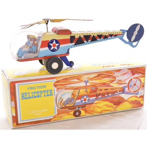 200 - Tinplate helicopters, one battery operated, one friction operated, light rust in places. (2)