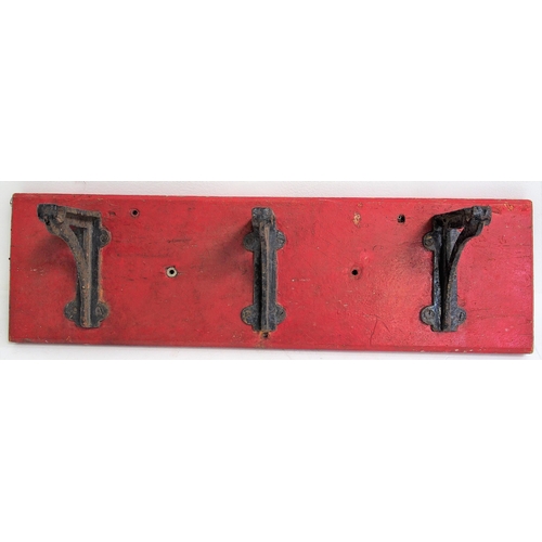 895 - Fire bucket cast iron brackets on original wooden back board, good ex service condition, back board ... 