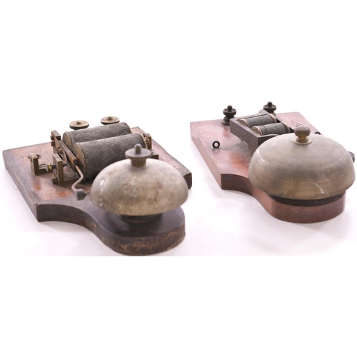 254 - Wall mounted bells with wooden cases, one lacks its cover, original condition. (2)