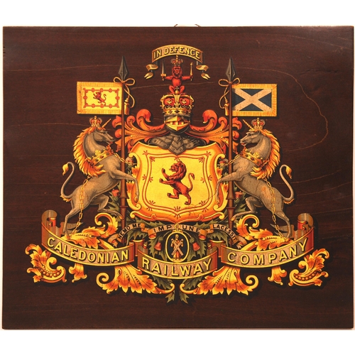 1079 - Caledonian Railway coat of arms, mounted on wooden board, the grain of the wood visible in the backg... 