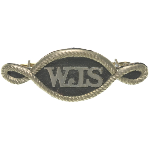 13 - A Worcester Joint Station cap badge with WJS initials and ropework border, approx. 3¼