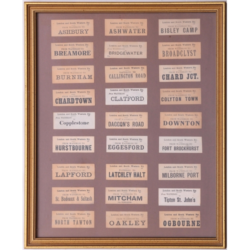 1097 - Mounted luggage labels, a frame containing 27 LSWR labels, three black sheets of GWR labels laid dow... 