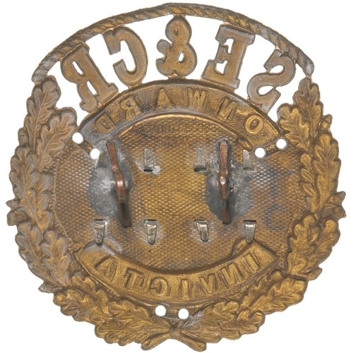 373 - A South Eastern and Chatham Railway Guard's cap badge, an ornate design bearing the mottos Onwards a... 