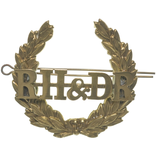 274 - A Romney, Hythe and Dymchurch Railway cap badge, displaying the company initials on laurel wreath, b... 