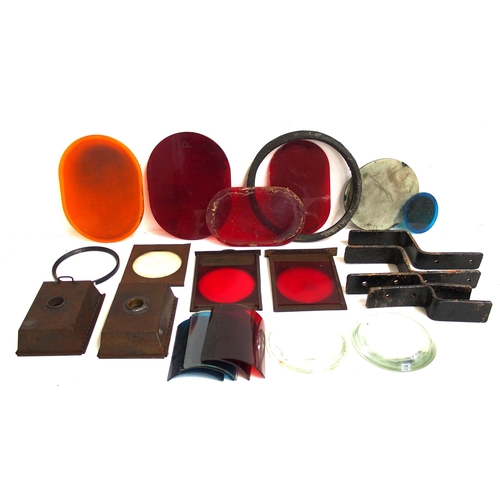 132 - Box of lamp spares including reservoirs, red shades, hand lamp internal glasses, lamp irons, bull's ... 