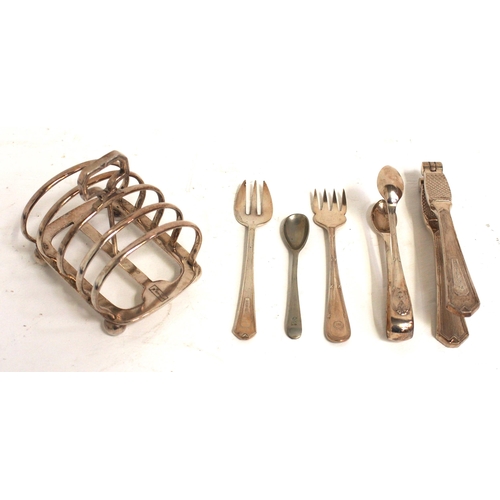 876 - LMS Hotels silver tableware - an attractive collection - toast rack, dessert spoons, nut crackers, s... 