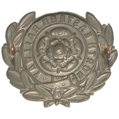 385 - A North Eastern Railway fireman's cap badge, embossed nickel, 2¼