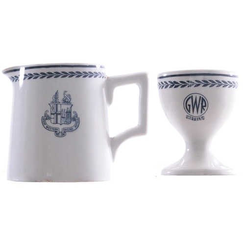 64 - A GWR Hotels egg cup, roundel pattern, together with a milk jug, coat of arms pattern, each china. (... 