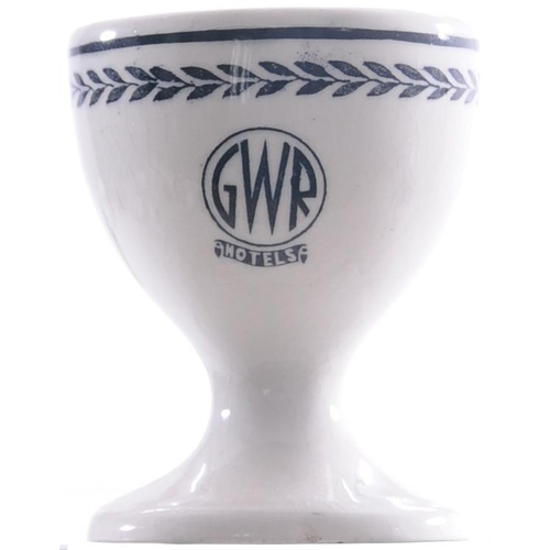 64 - A GWR Hotels egg cup, roundel pattern, together with a milk jug, coat of arms pattern, each china. (... 