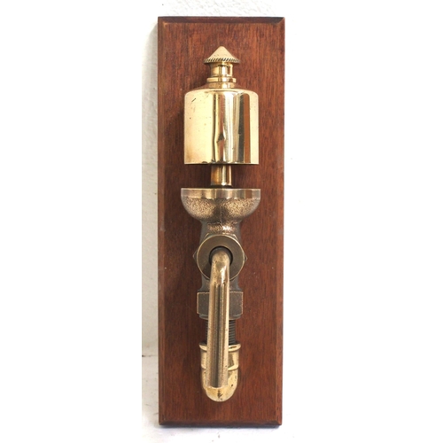 329 - Small brass steam whistle with isolation valve mounted on hardwood plaque, plaque dimensions 3½