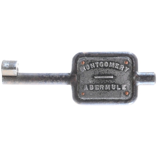 38 - A single line key token, MONTGOMERY-ABERMULE, (steel/cast metal plate), from the Welshpool to Moat L... 