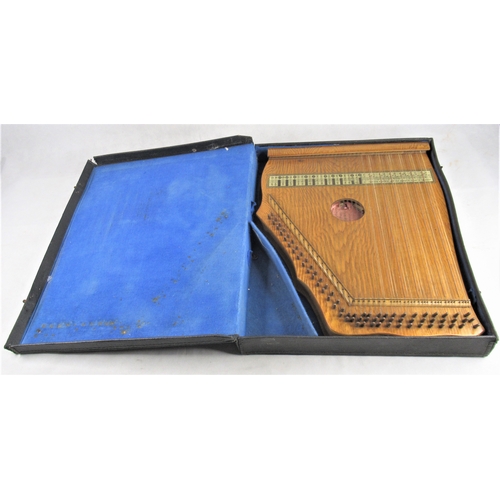 18 - A 20thC Zither / Auto Harp, approx. 52 x 40cm in black leather case.