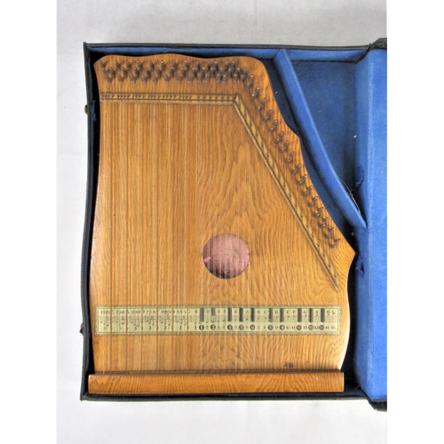 18 - A 20thC Zither / Auto Harp, approx. 52 x 40cm in black leather case.