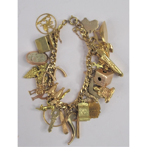 27 - A 9ct .375 Yellow Gold Charm Bracelet with 28 charms. Total weight approx. 61g.