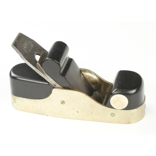 868 - A shapely brass smoother with ebony infill and scrolled wedge and 2 1/8