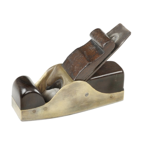 870 - A nice quality steel soled gunmetal smoother with rosewood infill and scrolled wedge and 2