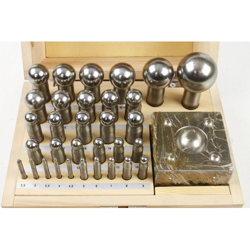 667 - An unused silversmith's set of 32 doming punches and a former in orig box F