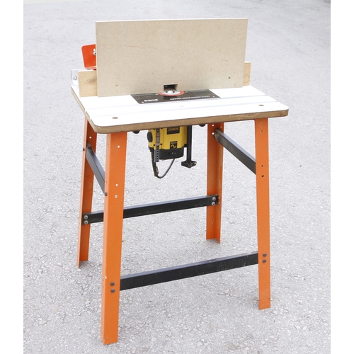 128 - A DEWALT router on table Pat tested