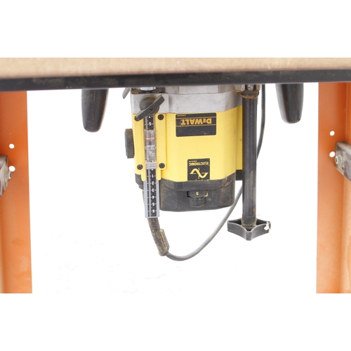 128 - A DEWALT router on table Pat tested