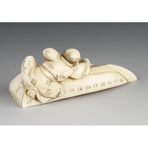 909 - An ivory okimono of a boy planing the bottom of an upturned boat 3