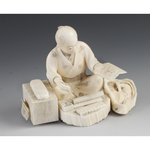 910 - An ivory okimono of a cloth merchant at work 3